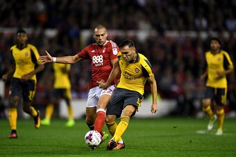 NOTTINGHAM, ENGLAND - SEPTEMBER 20:  Lucas Perez of Arsenal is challenged by Pajtim Kasami of Nottingham Forest during the EFL Cup Third Round match between Nottingham Forest and Arsenal at City Ground on September 20, 2016 in Nottingham, England.  (Photo
