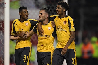 NOTTINGHAM, ENGLAND - SEPTEMBER 20:  Lucas Perez (C) of Arsenal celebrates scoring his team's third goal with Jeff Reine-Adelaide (L) and Chuba Akpom of Arsenal during the EFL Cup Third Round match between Nottingham Forest and Arsenal at City Ground on S