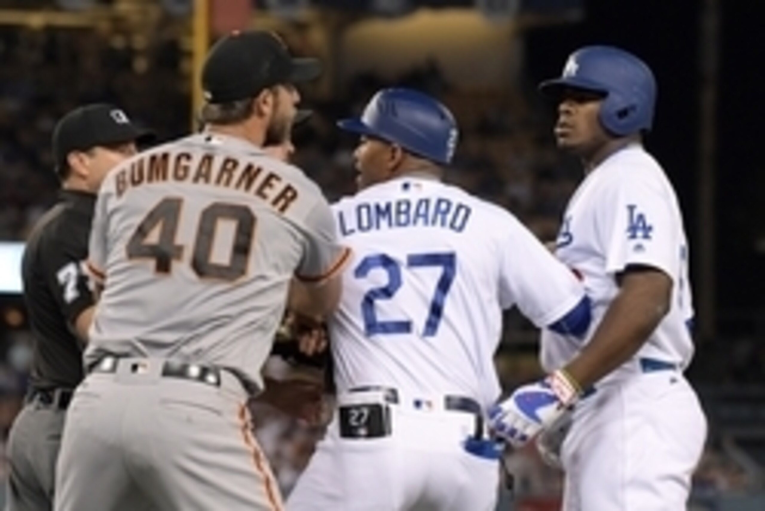 Sep 19, 2016; Los Angeles, CA, USA; San Francisco Giants pitcher Madison Bumgarner (40) and Los Angeles Dodgers right fielder Yasiel Puig (66) are restrained by Dodgers first base coach first base coach George Lomgard (27) during a MLB game at Dodger Stad