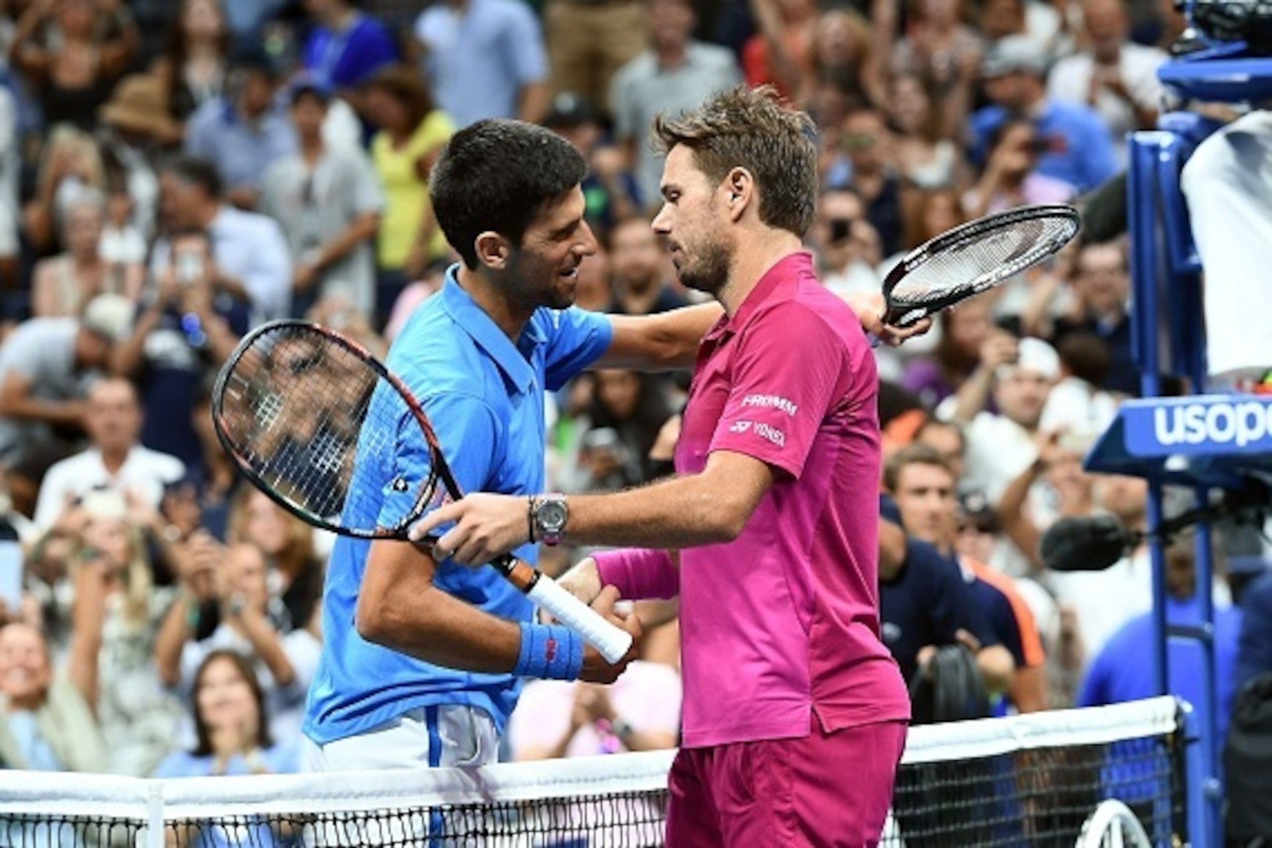 Stan Wawrinka of Switzerland embraces Novak Djokovic of Serbia during their 2016 US Open Men's Singles final match at the USTA Billie Jean King National Tennis Center in New York on September 11, 2016. / AFP / Jewel SAMAD        (Photo credit should read 