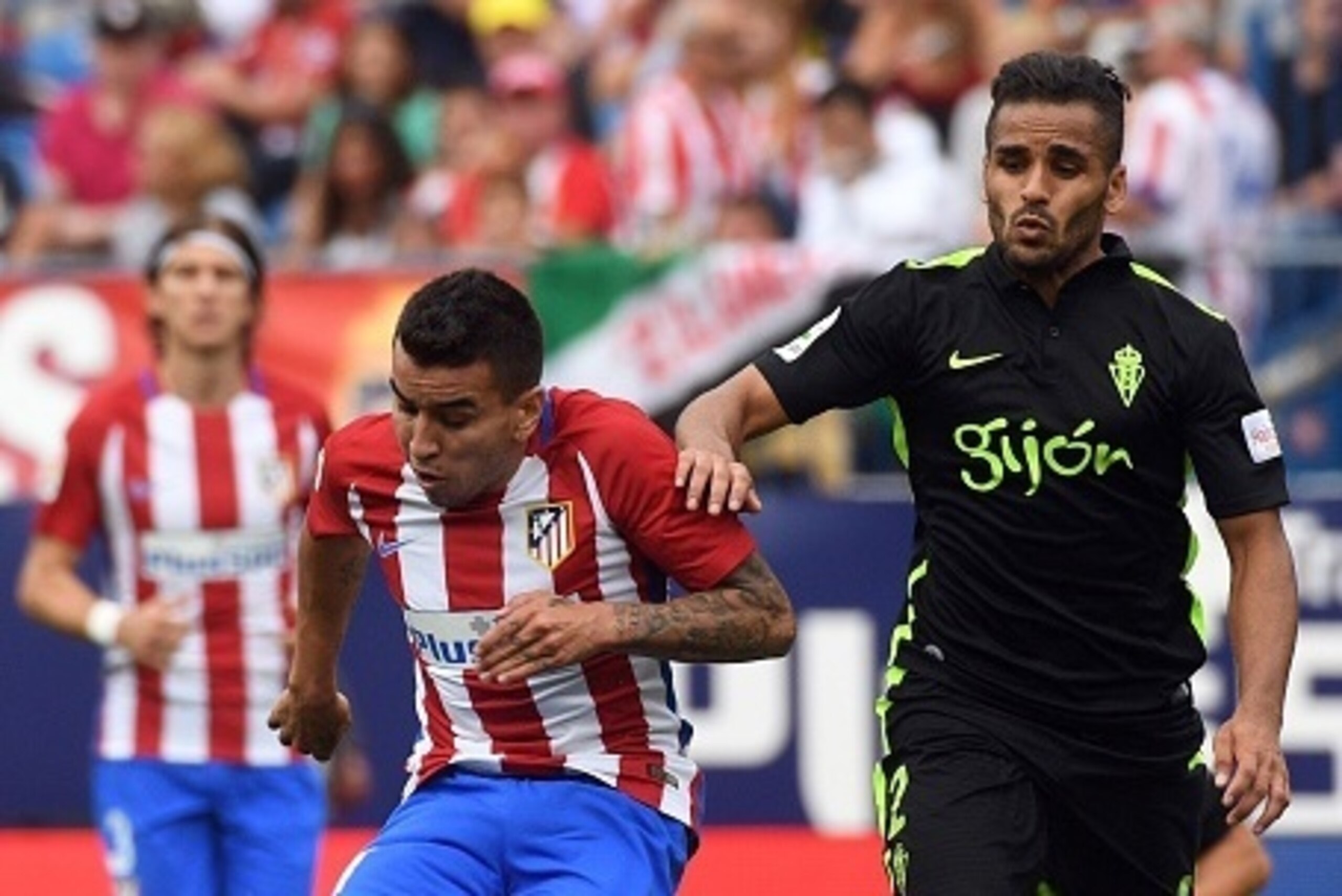 Atletico Madrid's Argentinian forward Angel Correa (L) kicks the ball past Sporting Gijon's Brazilian defender Douglas during the Spanish league football match Club Atletico de Madrid vs Real Sporting de Gijon at the Vicente Calderon stadium in Madrid on 