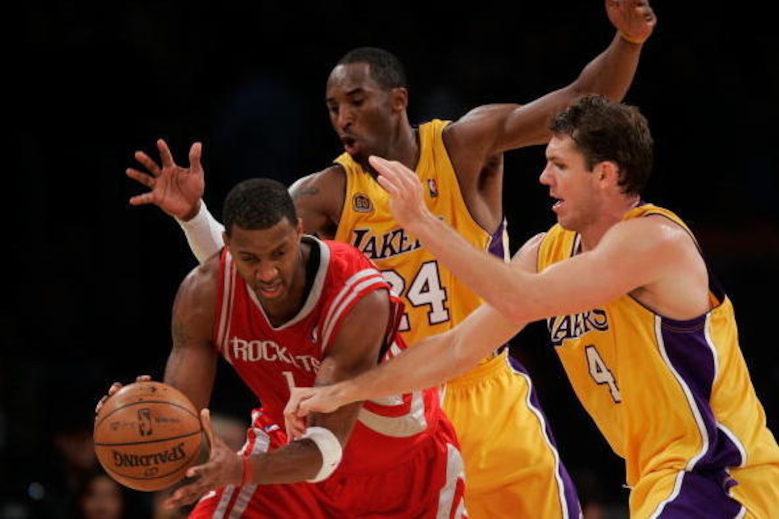 LOS ANGELES, CA - OCTOBER 30:  Tracy McGrady #1 of the Houston Rockets handles the ball under pressure from Kobe Bryant #24 and Luke Walton #4 of the Los Angeles Lakers during a game at Staples Center on October 30, 2007 in Los Angeles, California. NOTE T