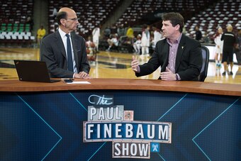 COLUMBIA, SC - FEBRUARY 08: South Carolina football head coach Will Muschamp (R) speaks with radio personality Paul Finebaum prior to the game between the Connecticut Huskies and the South Carolina Gamecocks at Colonial Life Arena on February 8, 2016 in C