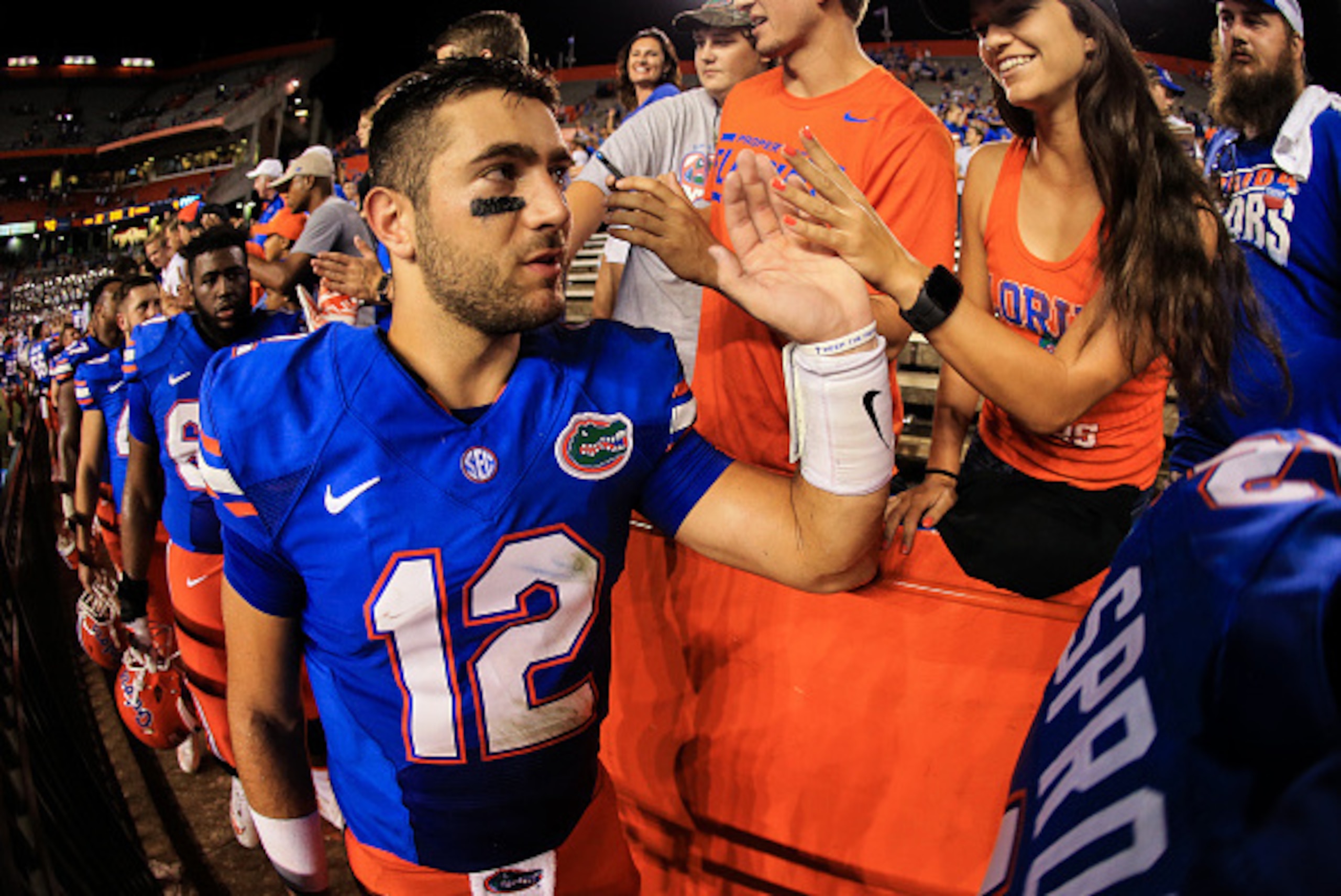 GAINESVILLE, FL - SEPTEMBER 17: Austin Appleby #12 of the Florida Gators slaps hands with fans after the game against the North Texas Mean Green at Ben Hill Griffin Stadium on September 17, 2016 in Gainesville, Florida. (Photo by Rob Foldy/Getty Images)