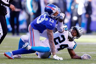 EAST RUTHERFORD, NJ - DECEMBER 20:  (NEW YORK DAILIES OUT)    Josh Norman #24 of the Carolina Panthers grabs the face mask of Odell Beckham #13 of the New York Giants during the first half on December 20, 2015 at MetLife Stadium in East Rutherford, New Je