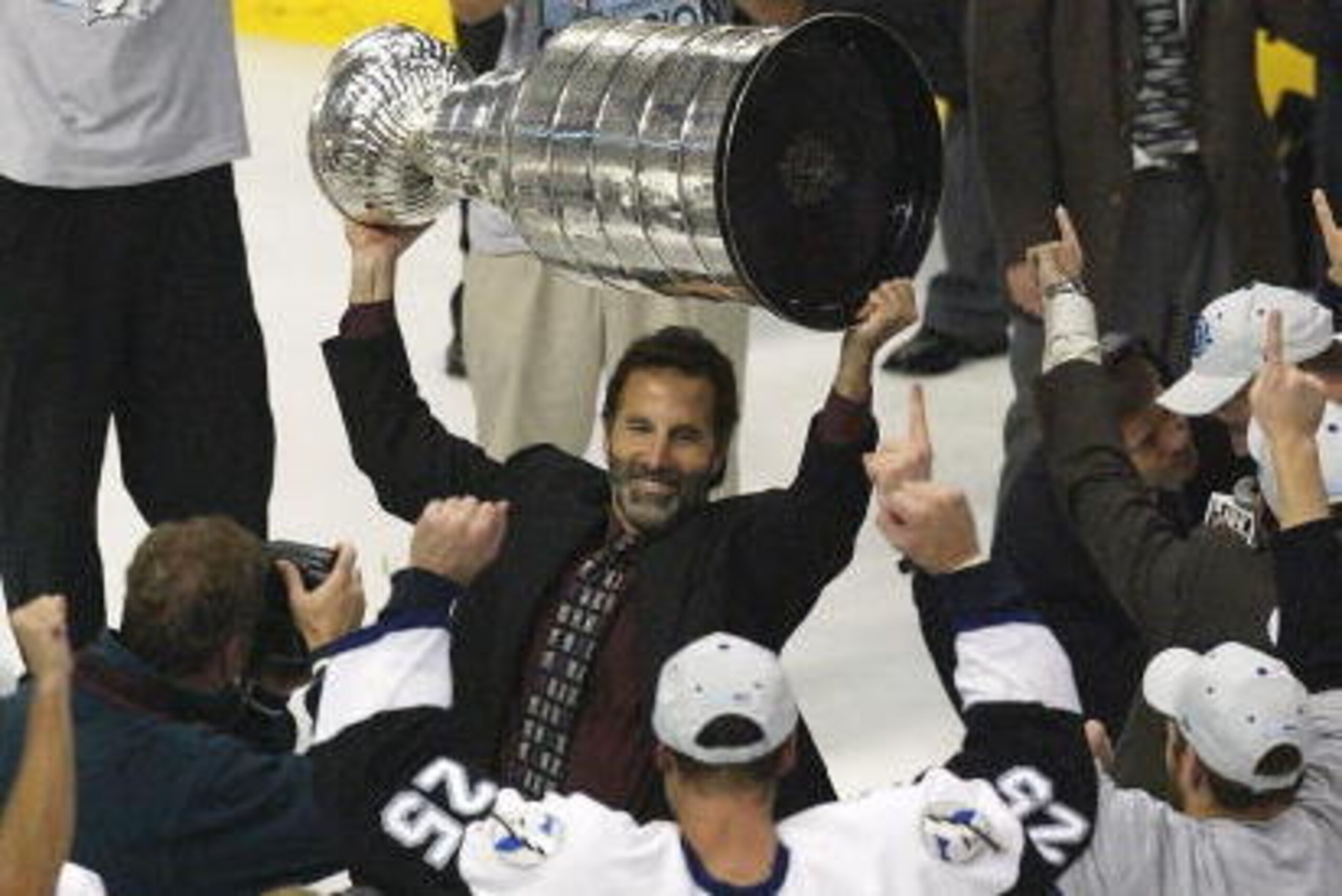 TAMPA, FL - JUNE 7: Coach John Tortorella of the Tampa Bay Lightning holds the Stanley Cup over his head while celebrating victory over the Calgary Flames with Dave Andreychuk #25 in game seven of the NHL Stanley Cup Finals on June 7, 2004 at the St. Pet TAMPA, FL - JUNE 7: Coach John Tortorella of the Tampa Bay Lightning holds the Stanley Cup over his head while celebrating victory over the Calgary Flames with Dave Andreychuk #25 in game seven of the NHL Stanley Cup Finals on June 7, 2004 at the St. Pet