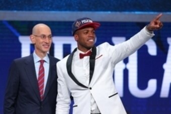 Jun 23, 2016; New York, NY, USA; Buddy Hield (Oklahoma) gestures to the crowd while standing with NBA commissioner Adam Silver after being selected as the number six overall pick to the New Orleans Pelicans in the first round of the 2016 NBA Draft at Barc