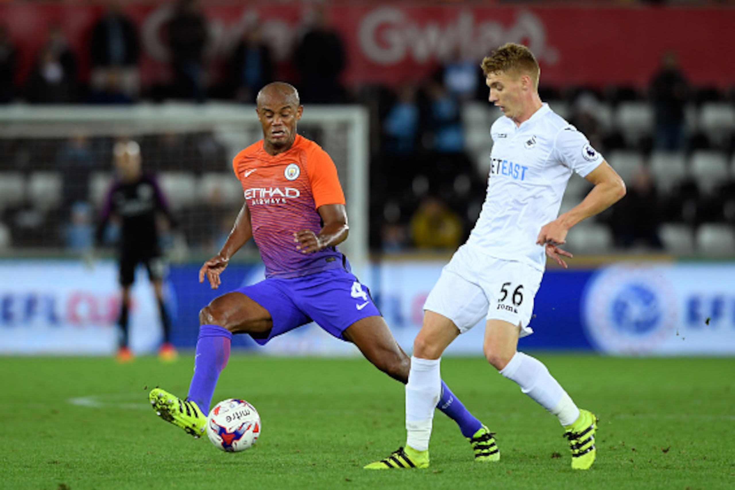 SWANSEA, WALES - SEPTEMBER 21:  Vincent Kompany of Manchester City closes down Jay Fulton of Swansea City during the  EFL Cup Third Round match between Swansea City and Manchester City at the Liberty Stadium on September 21, 2016 in Swansea, Wales.  (Phot