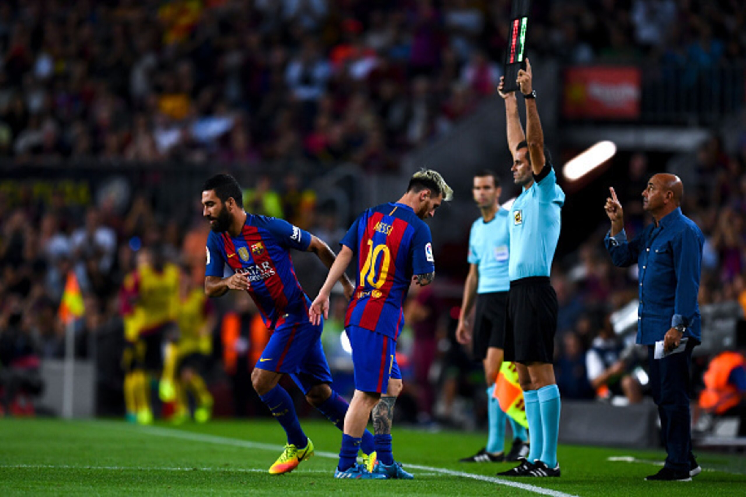 BARCELONA, SPAIN - SEPTEMBER 21:  Lionel Messi of FC Barcelona is comforted by his team mate Ardan Turan of FC Barcelona as he leaves the pitch injured during the La Liga match between FC Barcelona and Club Atletico de Madrid at the Camp Nou stadium on Se