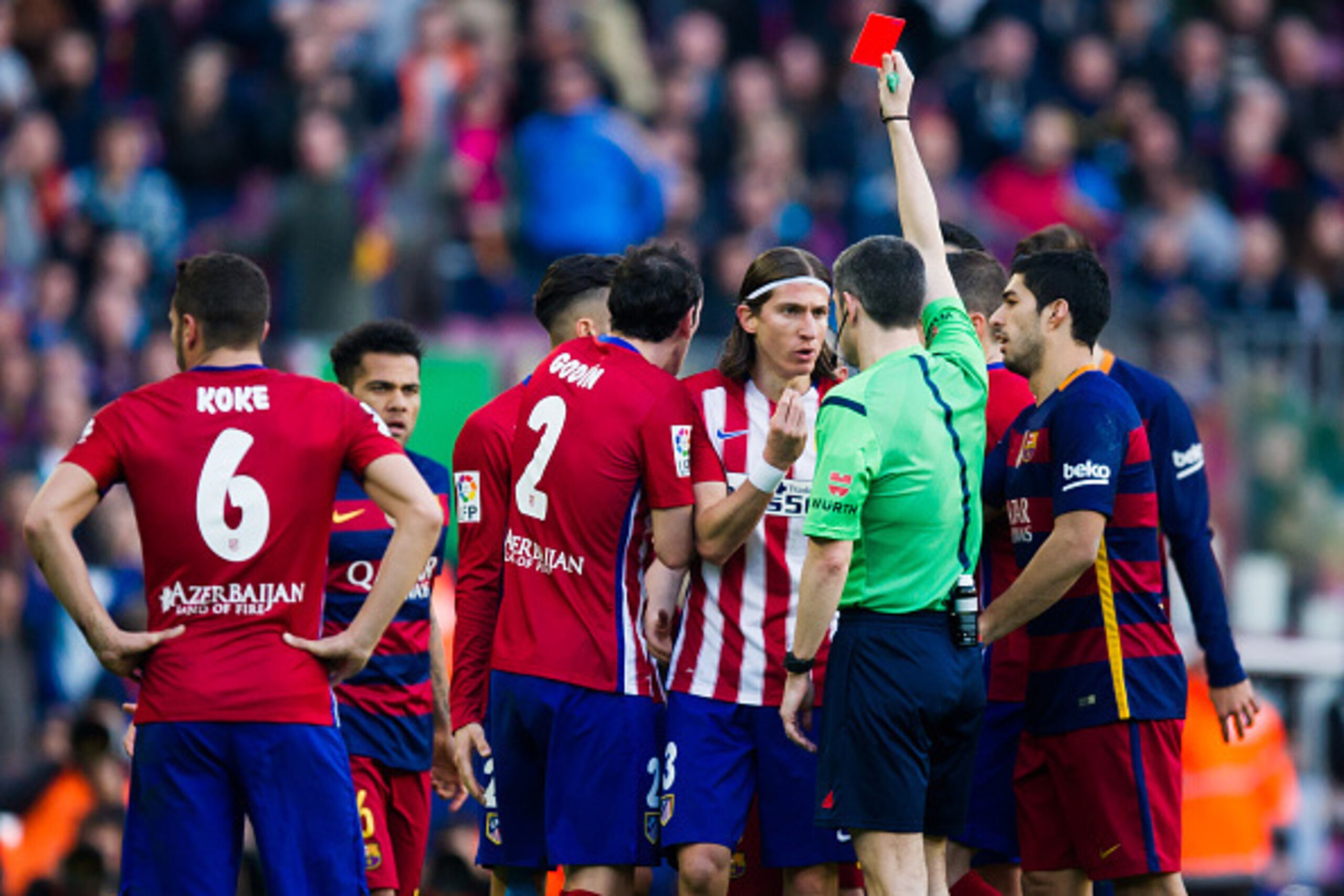 BARCELONA, SPAIN - JANUARY 30: Referee Alberto Undiano Mallenco shows a red card to Filipe Luis (3rd R) after fouling Lionel Messi during the La Liga match between FC Barcelona and Club Atletico de Madrid at Camp Nou on January 30, 2016 in Barcelona, Spai BARCELONA, SPAIN - JANUARY 30: Referee Alberto Undiano Mallenco shows a red card to Filipe Luis (3rd R) after fouling Lionel Messi during the La Liga match between FC Barcelona and Club Atletico de Madrid at Camp Nou on January 30, 2016 in Barcelona, Spai