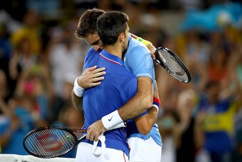 RIO DE JANEIRO, BRAZIL - AUGUST 07:  Juan Martin Del Potro of Argentina is congratulated by Novak Djokovic of Serbia after his victory in their singles match on Day 2 of the Rio 2016 Olympic Games at the Olympic Tennis Centre on August 7, 2016 in Rio de J