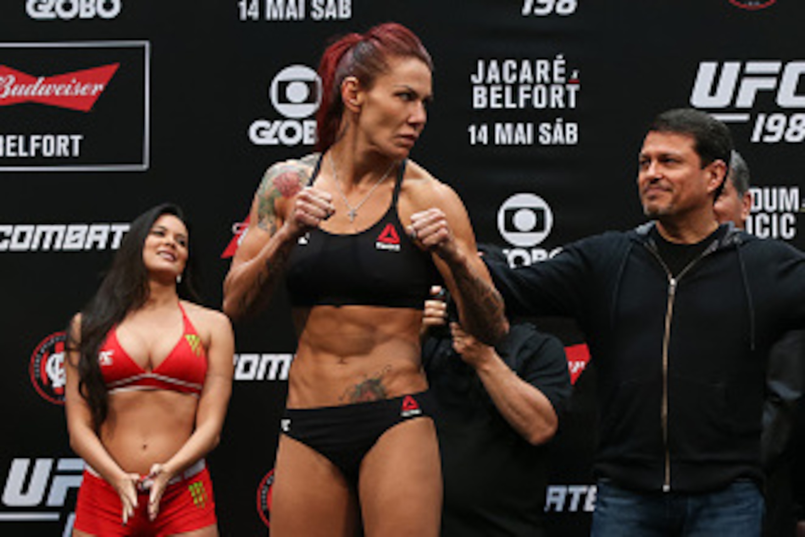CURITIBA, BRAZIL - MAY 13:  (L-R) Opponents Cris Cyborg Justino of Brazil and Leslie Smith of the United States face off during the UFC 198 weigh-in at Arena da Baixada stadium on May 13, 2016 in Curitiba, Brazil. (Photo by Buda Mendes/Getty Images)