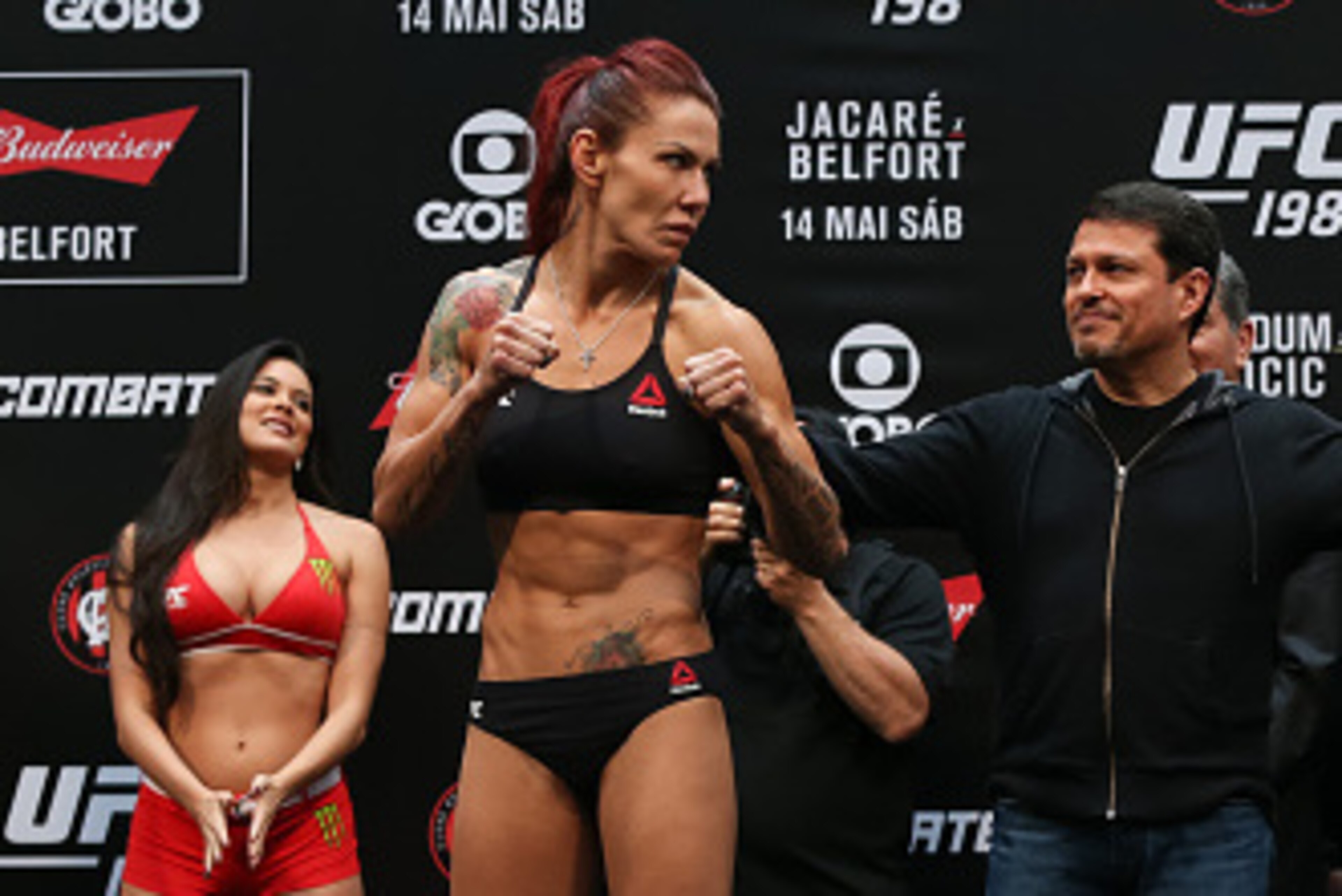 CURITIBA, BRAZIL - MAY 13:  (L-R) Opponents Cris Cyborg Justino of Brazil and Leslie Smith of the United States face off during the UFC 198 weigh-in at Arena da Baixada stadium on May 13, 2016 in Curitiba, Brazil. (Photo by Buda Mendes/Getty Images)