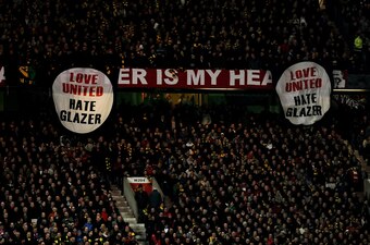 MANCHESTER, ENGLAND - MARCH 10: Manchester United fans reveal anti Glazer banners during the UEFA Champions League First Knockout Round, second leg match between Manchester United and AC Milan at Old Trafford on March 10, 2010 in Manchester, England. (Pho