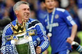 Chelsea's Italian manager Carlo Ancelotti celebrates with the Barclays Premier League trophy after Chelsea win the title with a 8-0 victory over Wigan Athletic in the English Premier League football match at Stamford Bridge, West London, England, on May 9