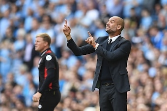 Manchester City's Spanish manager Pep Guardiola (R) gestures on the touchline next to Bournemouth's English manager Eddie Howe (L) during the English Premier League football match between Manchester City and Bournemouth at the Etihad Stadium in Manchester