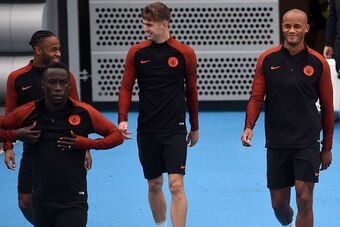 Manchester City's English midfielder Raheem Sterling (L), Manchester City's French defender Bacary Sagna (2L), Manchester City's English defender John Stones (C) and Manchester City's Belgian defender Vincent Kompany arrive for a training session at the C