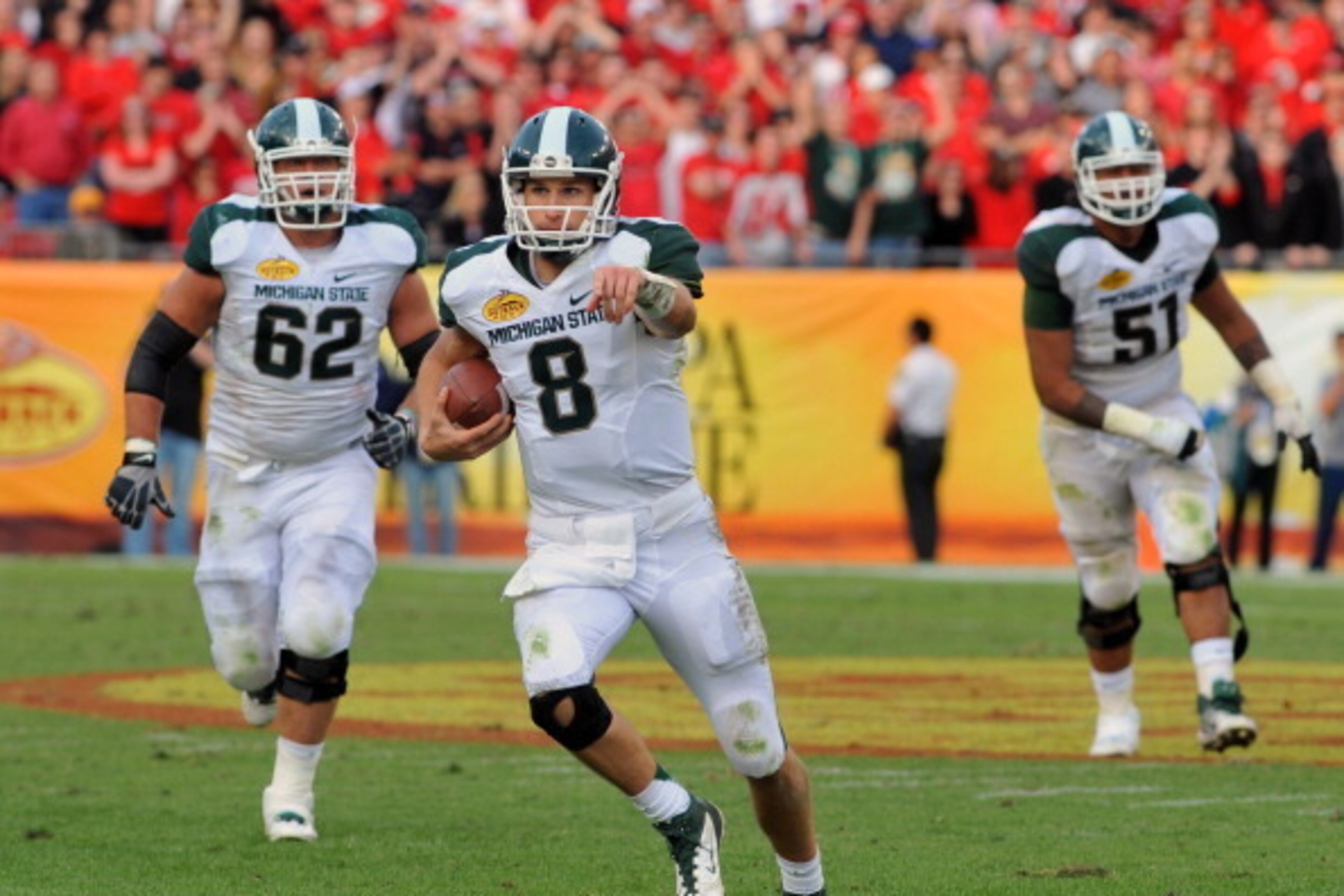 TAMPA, FL - JANUARY 02: Quarterback Kirk Cousins #8 of the Michigan State Spartans runs the ball against the Georgia Bulldogs in the Outback Bowl January 2, 2012 at Raymond James Stadium in Tampa, Florida. (Photo by Al Messerschmidt/Getty Images)