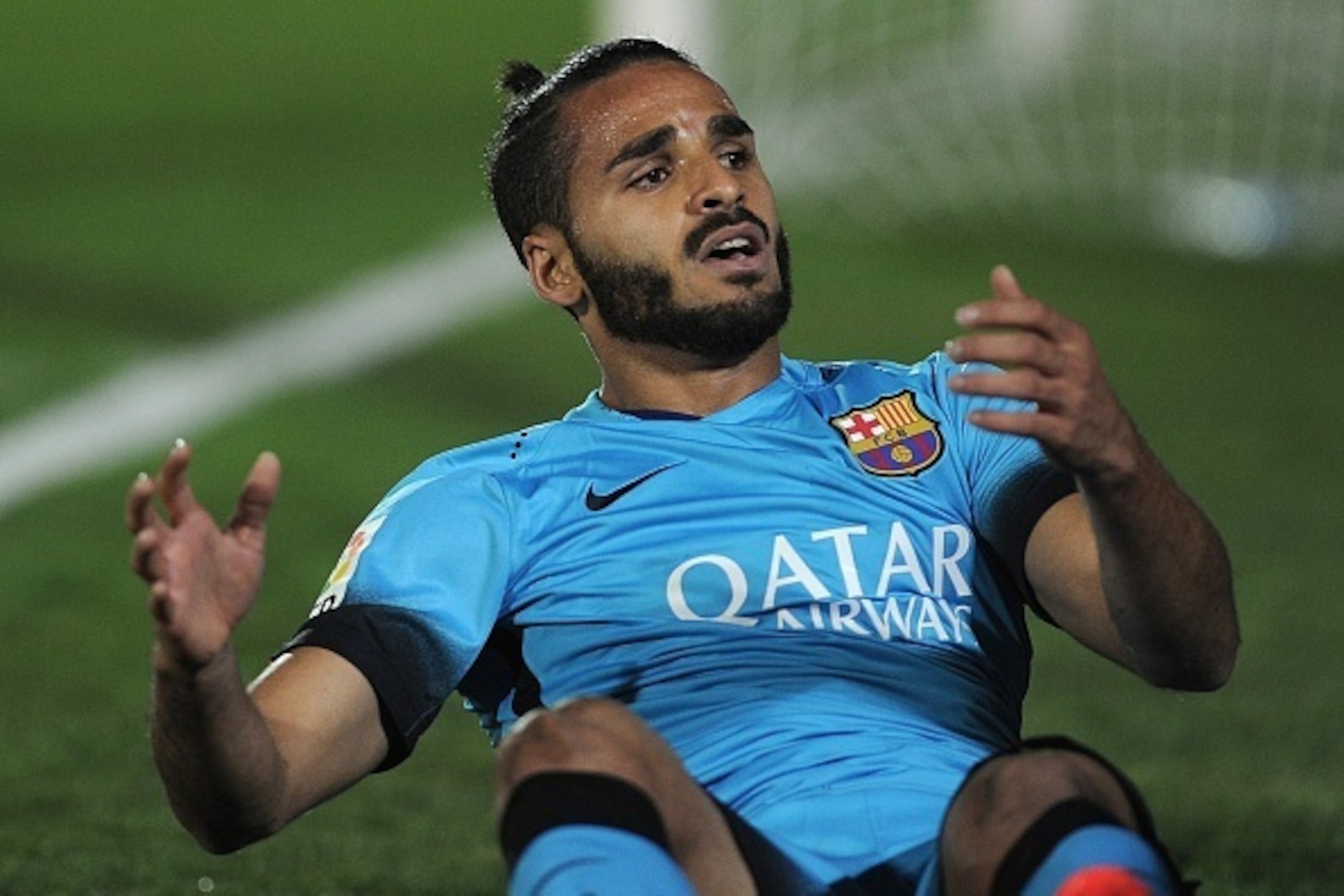 Barcelona's Brazilian defender Douglas sits on the field during the Spanish Copa del Rey (King's Cup) Round of 32 first leg football match CF Villanovense vs FC Barcelona at the Romero Cuerda stadium in Villanueva de la Serena on October 28, 2015. AFP PHO