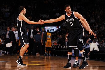 DENVER, CO - MARCH 4: Brook Lopez #11 of the Brooklyn Nets high fives his teammate Bojan Bogdanovic #44 of the Brooklyn Nets during the game against the Denver Nuggets on March 4, 2016 at the Pepsi Center in Denver, Colorado. NOTE TO USER: User expressly 