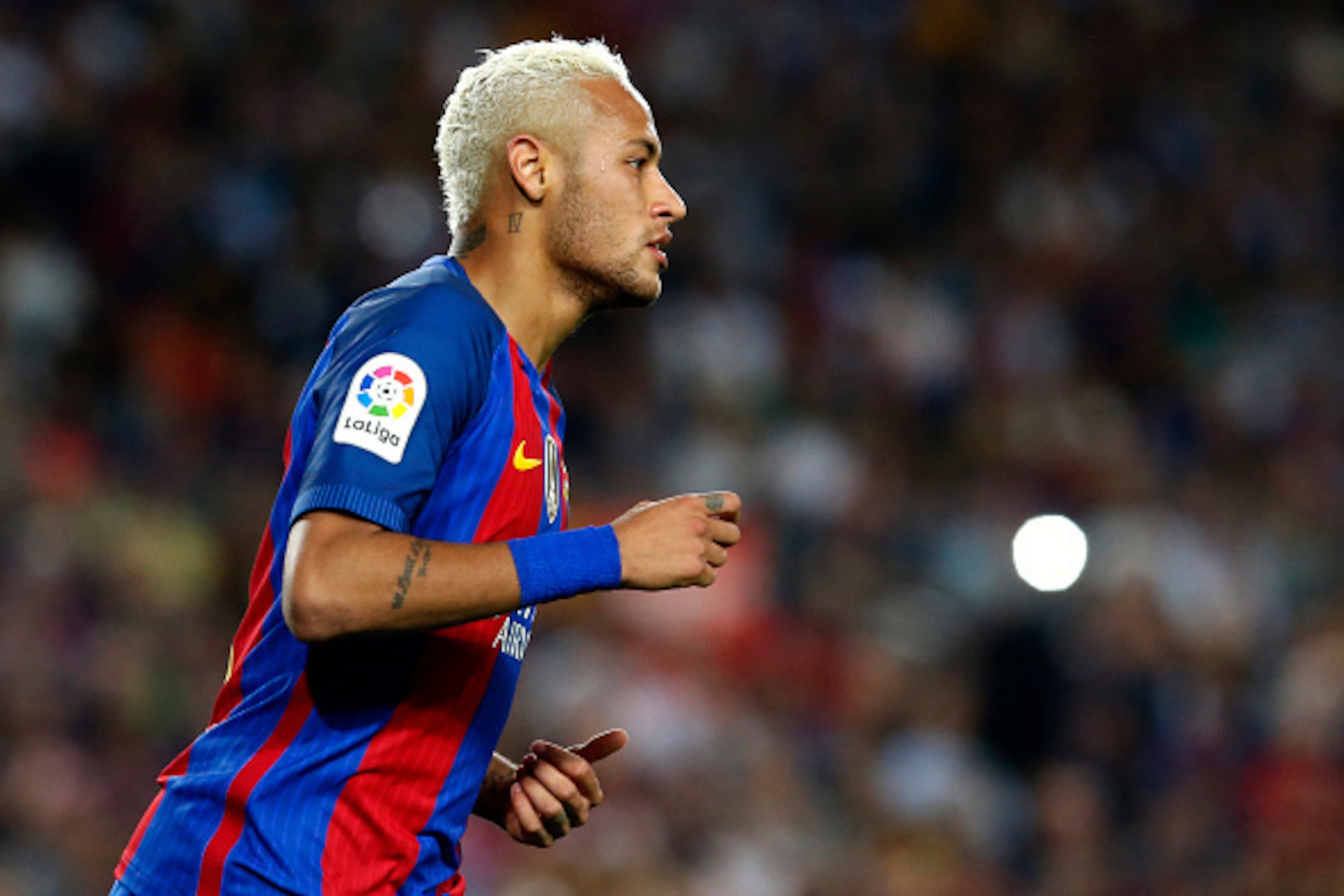 Barcelona's Brazilian forward Neymar runs during the Spanish league football match FC Barcelona vs Atletico de Madrid at the Camp Nou stadium in Barcelona on September 21, 2016. / AFP / PAU BARRENA        (Photo credit should read PAU BARRENA/AFP/Getty Im