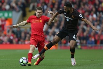 Liverpool's English midfielder James Milner (L) vies with Hull City's Egyptian midfielder Ahmed Elmohamady during the English Premier League football match between Liverpool and Hull City at Anfield in Liverpool, north west England on September 24, 2016. 