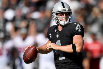 OAKLAND, CA - SEPTEMBER 18:  Derek Carr #4 of the Oakland Raiders drops back to pass against the Atlanta Falcons during the second half of their NFL game at the Oakland-Alameda County Coliseum on September 18, 2016 in Oakland, California.  (Photo by Thear