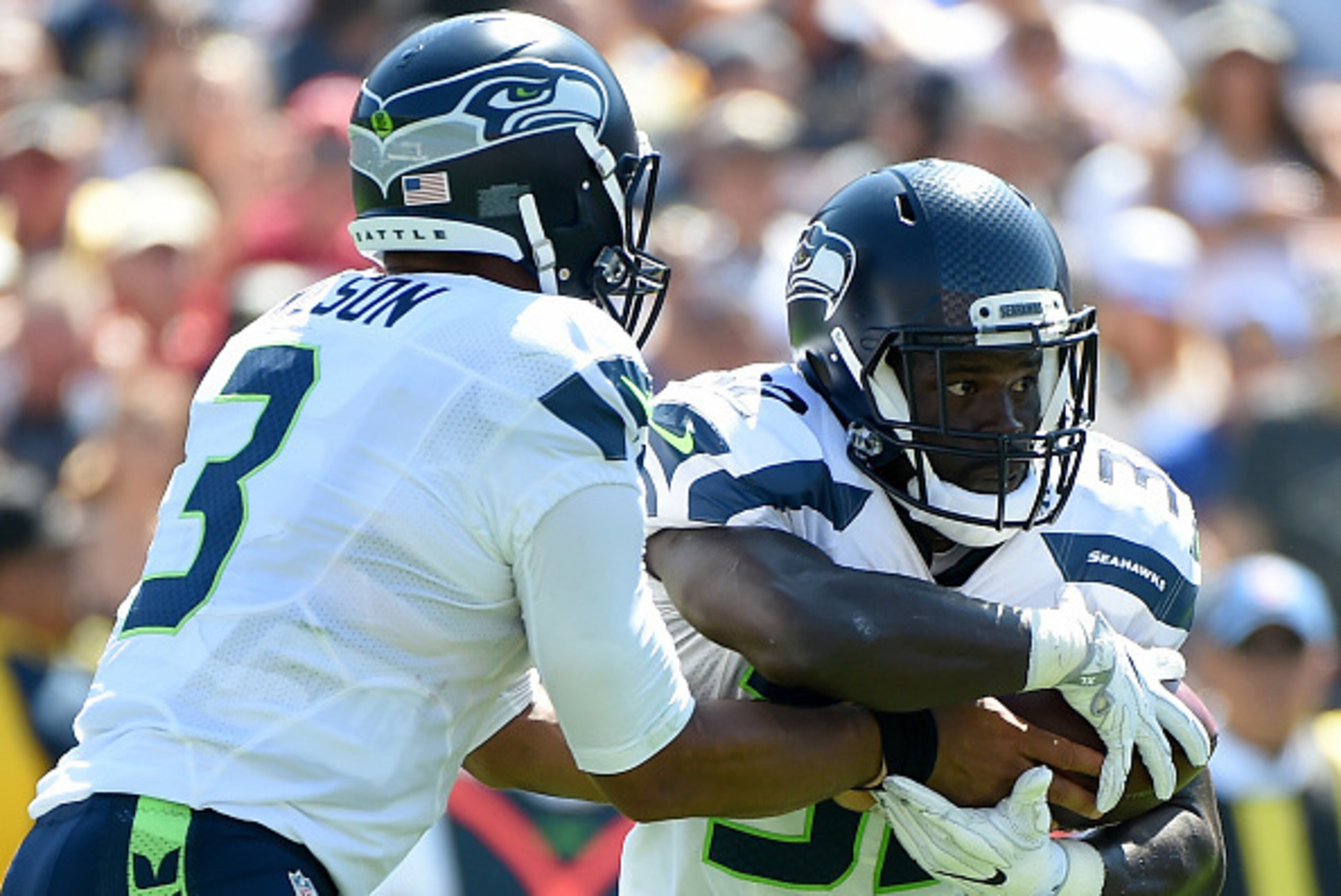 LOS ANGELES, CA - SEPTEMBER 18:  Christine Michael #32 of the Seattle Seahawks takes a handoff from Russell Wilson #3 during the second quarter of the home opening NFL game between the Los Angeles Rams and the Seattle Seahawks at Los Angeles Coliseum on S
