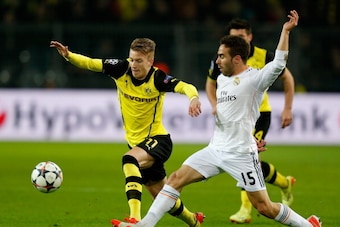 DORTMUND, GERMANY - APRIL 08:  Daniel Carvajal of Real Madrid battles for the ball with Marco Reus of Borussia Dortmund during the UEFA Champions League Quarter Final second leg match between Borussia Dortmund and Real Madrid at Signal Iduna Park on April