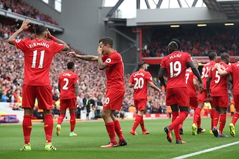 LIVERPOOL, ENGLAND - SEPTEMBER 24:  Philippe Coutinho of Liverpool celebrates with Roberto Firmino of Liverpool  as he scores their fourth goal during the Premier League match between Liverpool and Hull City at Anfield on September 24, 2016 in Liverpool, 