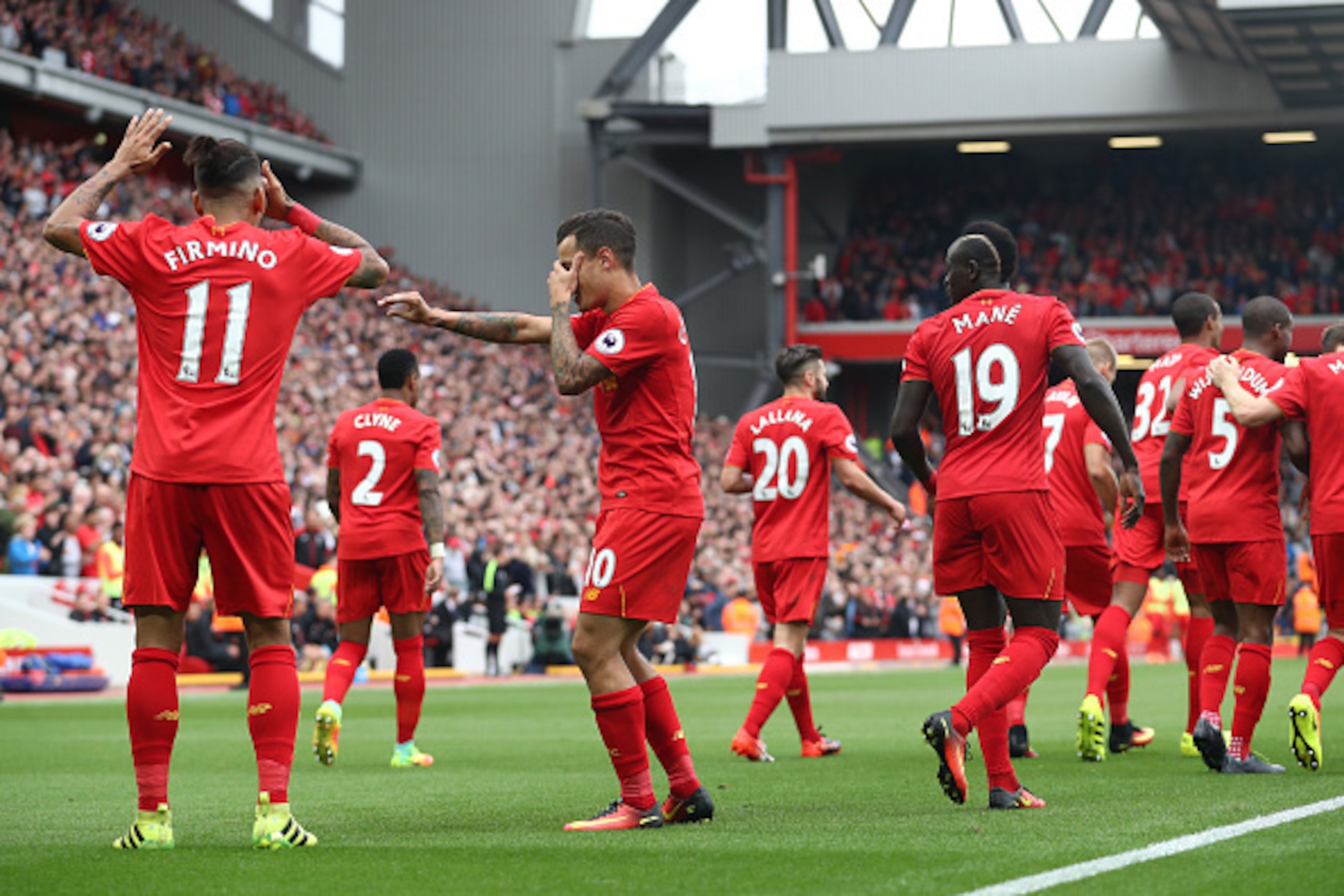 LIVERPOOL, ENGLAND - SEPTEMBER 24:  Philippe Coutinho of Liverpool celebrates with Roberto Firmino of Liverpool  as he scores their fourth goal during the Premier League match between Liverpool and Hull City at Anfield on September 24, 2016 in Liverpool, 