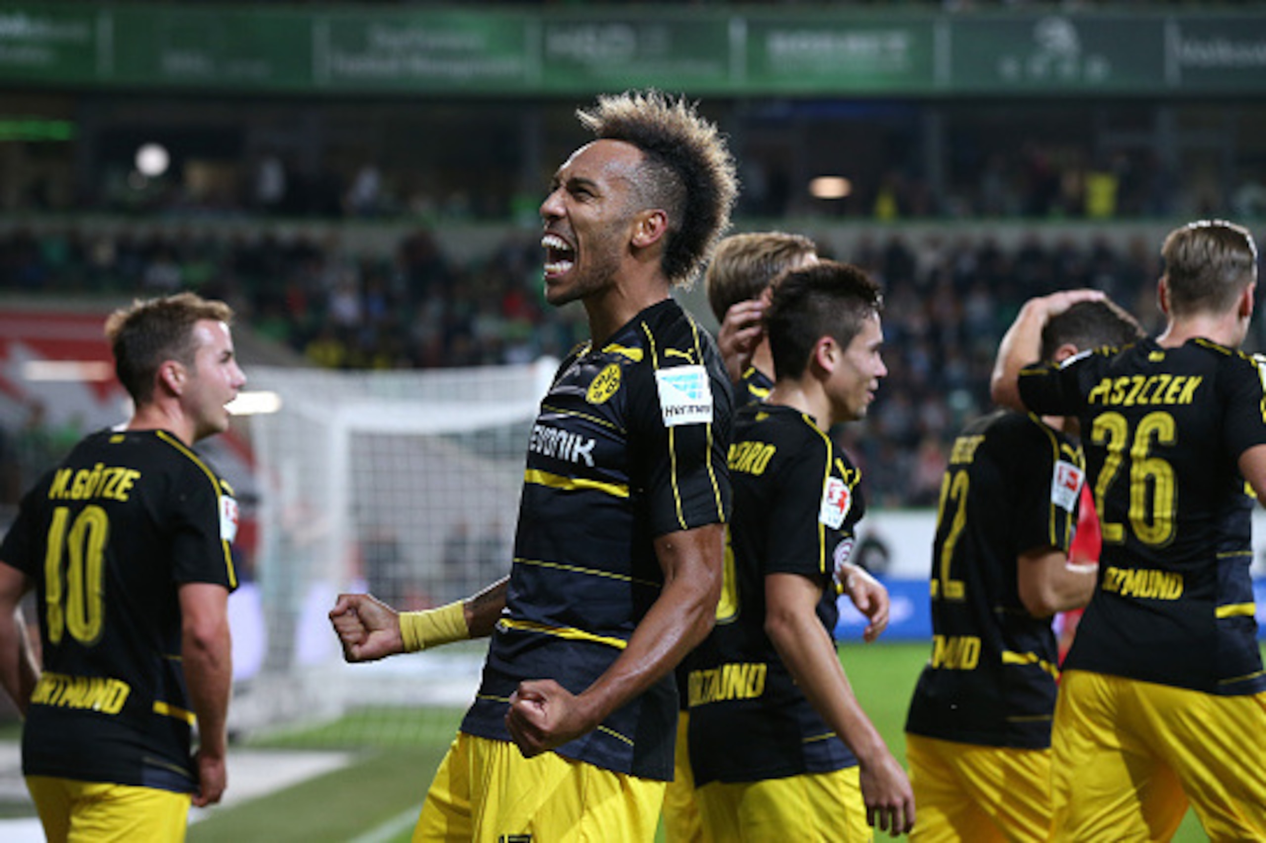 WOLFSBURG, GERMANY - SEPTEMBER 20: Pierre-Emerick Aubameyang (C) of Dortmund celebrates after scoring his team's second goal during the Bundesliga match between VfL Wolfsburg and Borussia Dortmund at Volkswagen Arena on September 21, 2016 in Wolfsburg, Ge
