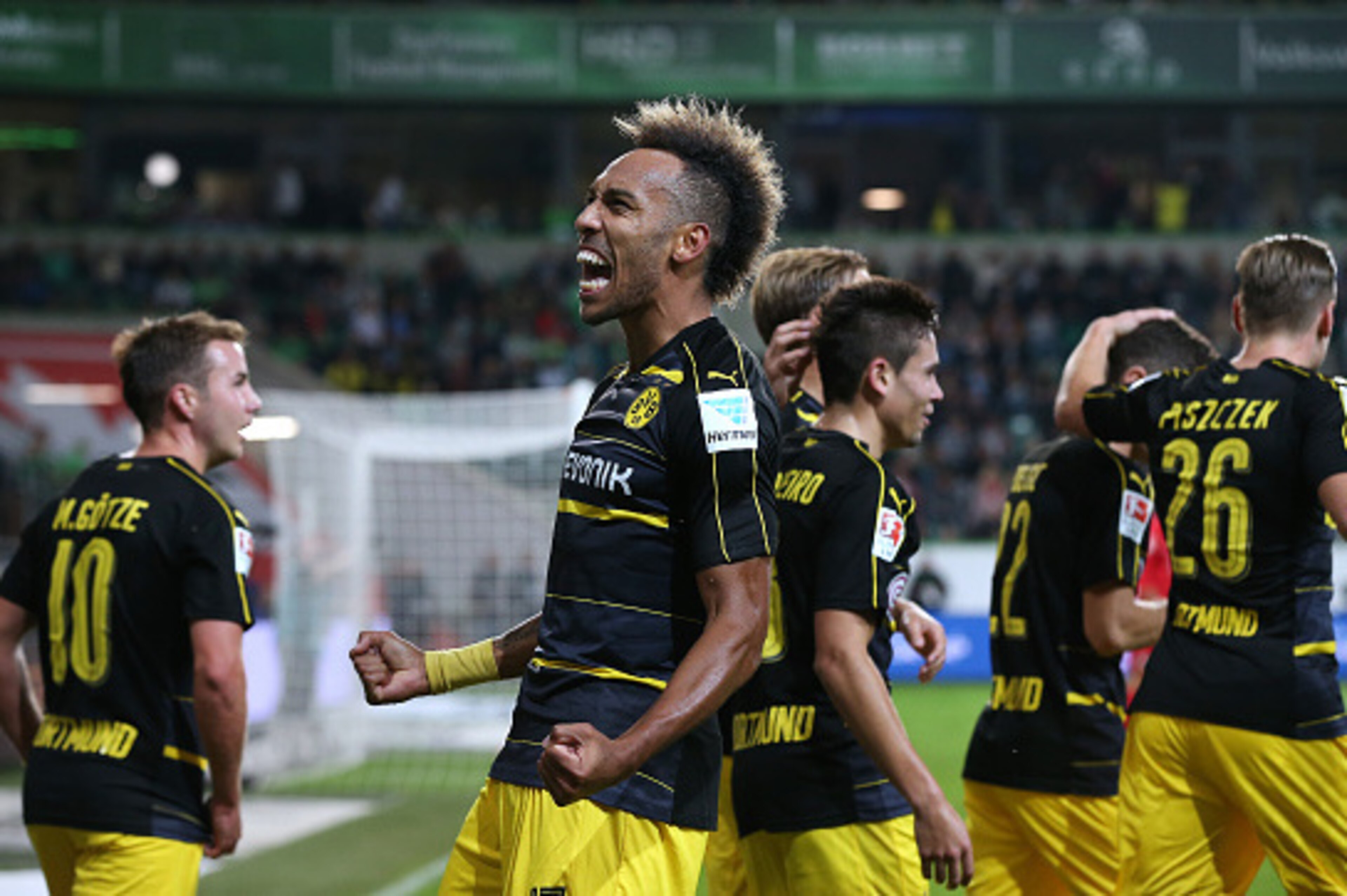 WOLFSBURG, GERMANY - SEPTEMBER 20: Pierre-Emerick Aubameyang (C) of Dortmund celebrates after scoring his team's second goal during the Bundesliga match between VfL Wolfsburg and Borussia Dortmund at Volkswagen Arena on September 21, 2016 in Wolfsburg, Ge WOLFSBURG, GERMANY - SEPTEMBER 20: Pierre-Emerick Aubameyang (C) of Dortmund celebrates after scoring his team's second goal during the Bundesliga match between VfL Wolfsburg and Borussia Dortmund at Volkswagen Arena on September 21, 2016 in Wolfsburg, Ge
