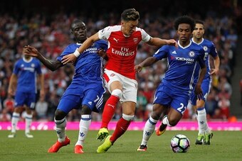Arsenal's German midfielder Mesut Ozil (C) battles with Chelsea's Brazilian midfielder Willian (R) and Chelsea's French midfielder N'Golo Kante (L) during the English Premier League football match between Arsenal and Chelsea at The Emirates stadium in Lon