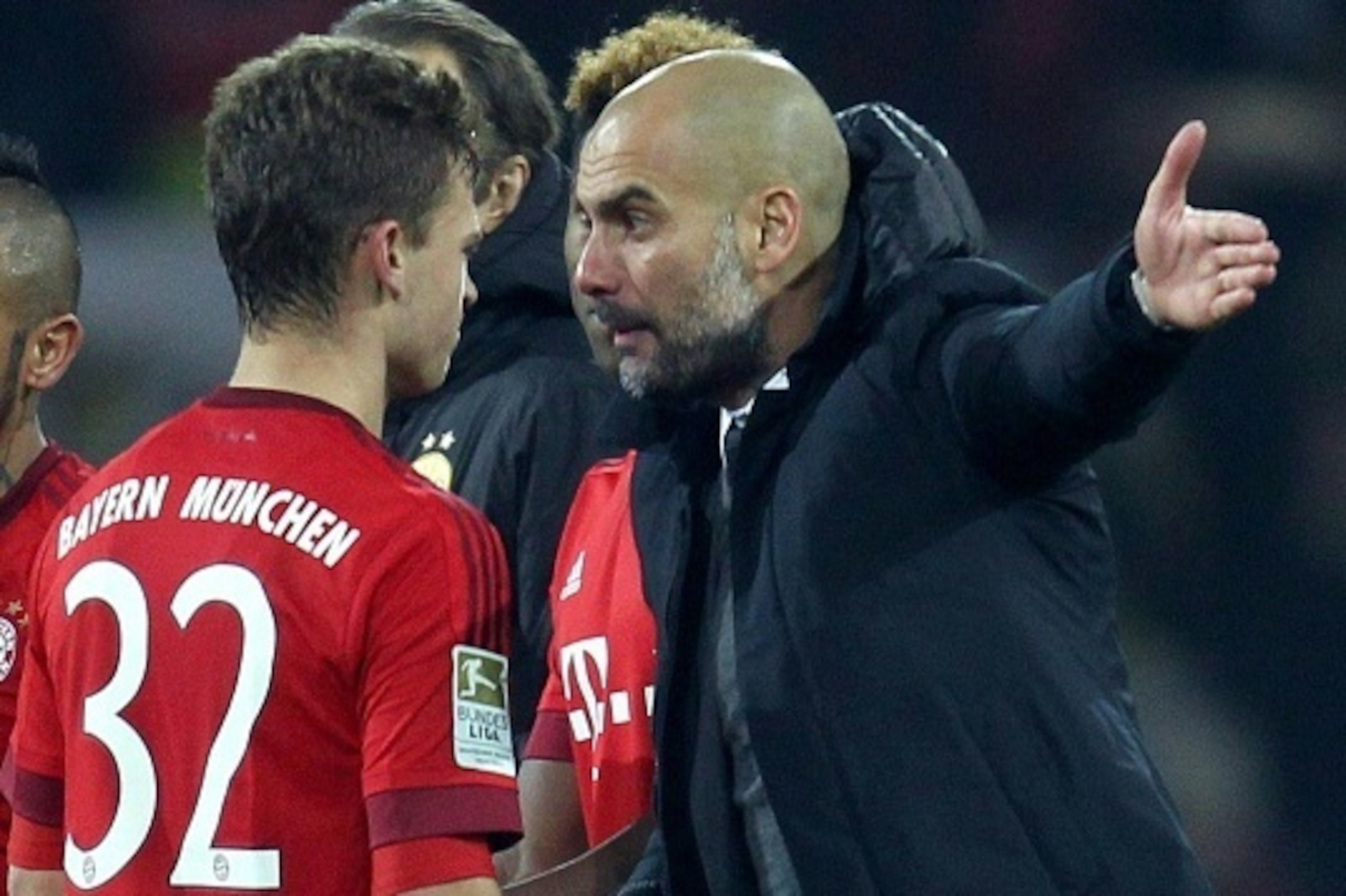 Bayern Munich's Spanish head coach Pep Guardiola reacts to midfielder Joshua Kimmich during the German first division Bundesliga football match of Borussia Dortmund v FC Bayern Muenchen in Dortmund, on March 5, 2016. / AFP / Ina Fassbender / NO Getty Imag