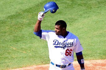 LOS ANGELES, CA - SEPTEMBER 25:  Yasiel Puig #66 of the Los Angeles Dodgers tips his hat to Vin Scully as he announces his final home game for the Dodgers during the first inning against the Colorado Rockies at Dodger Stadium on September 25, 2016 in Los 
