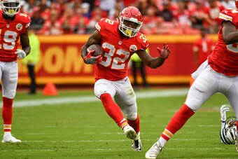 KANSAS CITY, MO - SEPTEMBER 25: Running back Spencer Ware #32 of the Kansas City Chiefs rushes through a hole against the New York Jets at Arrowhead Stadium during the first quarter of the game on September 25, 2016 in Kansas City, Missouri. (Photo by Pet