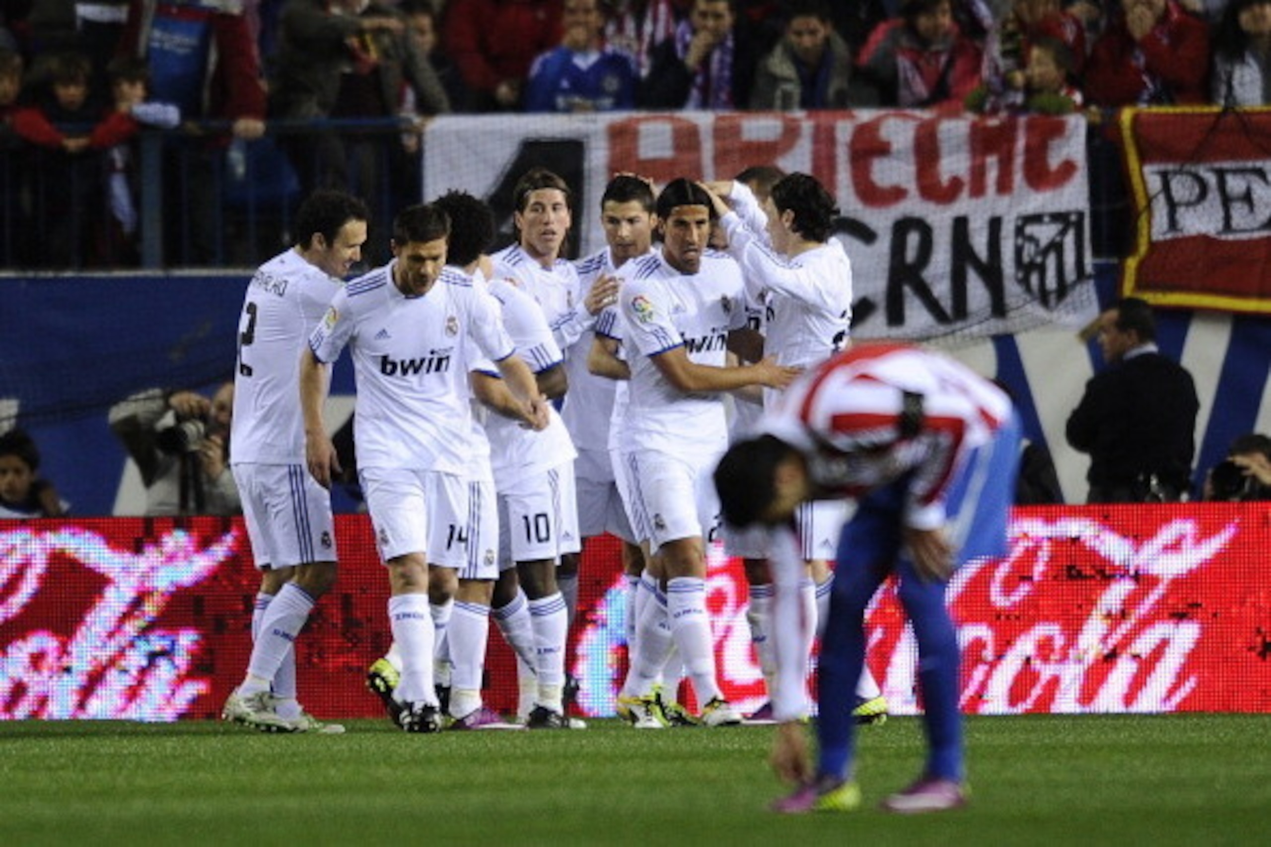 Real Madrid's players celebrate the goal of Real Madrid's French forward Karim Benzema during their Spanish league football match Atletico Madrid vs Real Madrid on March 19, 2011 at the Vicente Calderon stadium in Madrid. AFP PHOTO/ PIERRE-PHILIPPE MARCOU