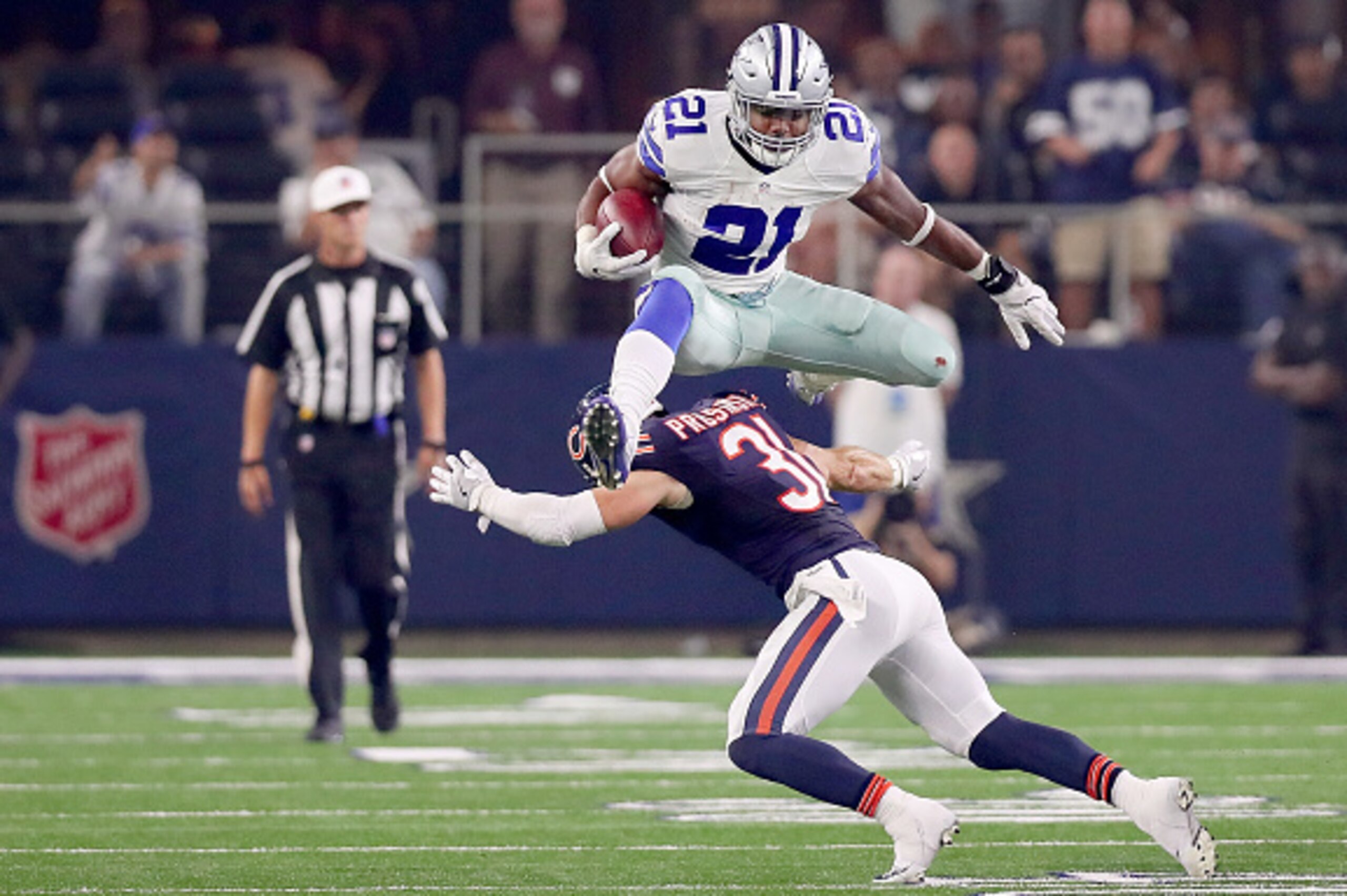 ARLINGTON, TX - SEPTEMBER 25:  Ezekiel Elliott #21 of the Dallas Cowboys hurdles Chris Prosinski #31 of the Chicago Bears while carrying the ball in the fourth quarter at AT&T Stadium on September 25, 2016 in Arlington, Texas.  (Photo by Tom Pennington/Ge