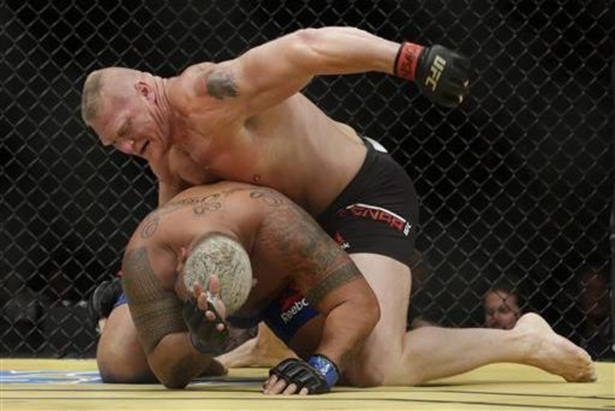 Lesnar pounds Mark Hunt on the ground at UFC 200.