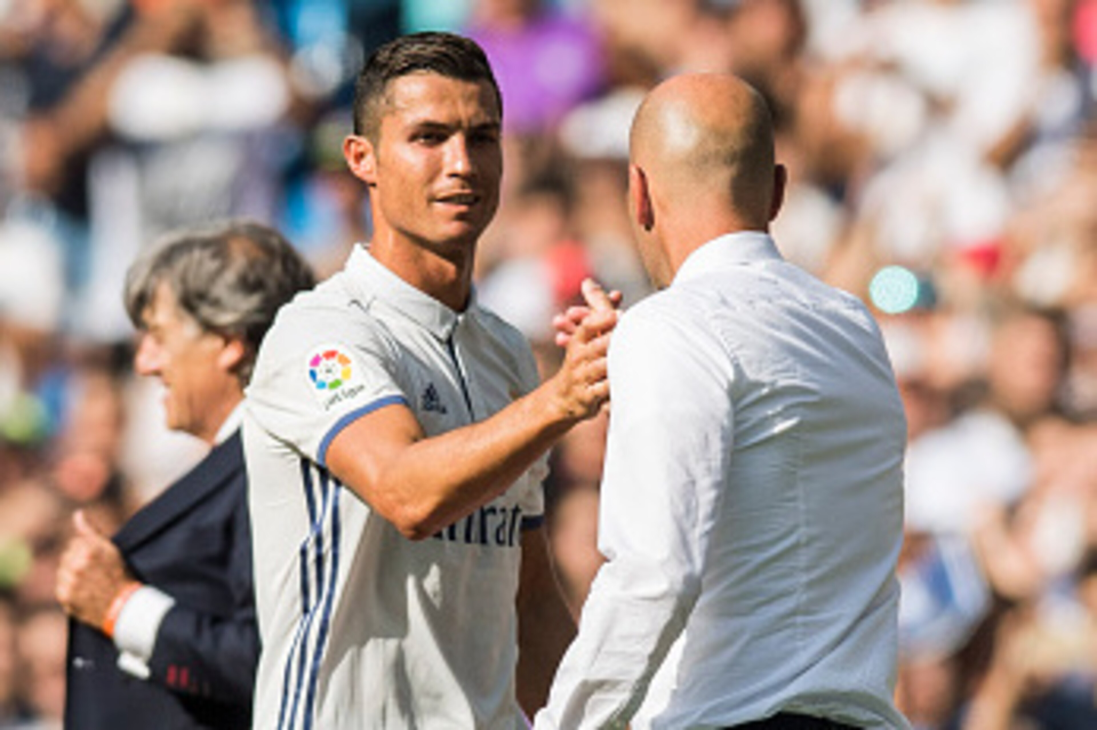 MADRID - SEPTEMBER 10: Cristiano Ronaldo of Real Madrid shakes hands with head coach Zinedine Zidane after being substituted during the La Liga match between Real Madrid and Osasuna at the Santiago Bernabeu Stadium on 10 September 2016 in Madrid, Spain. (