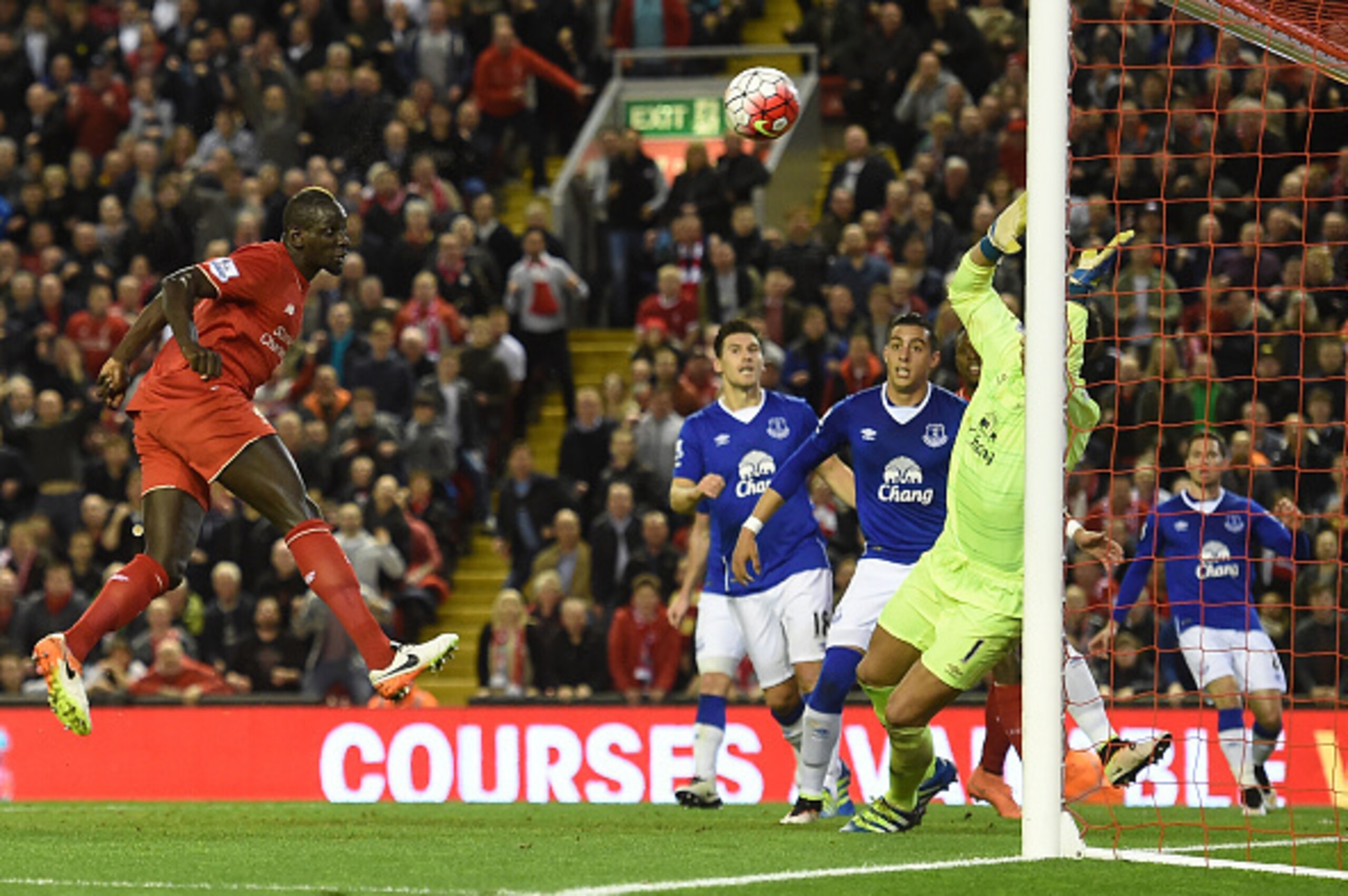 Liverpool's French defender Mamadou Sakho (L) heads the ball to score past Everton's Spanish goalkeeper Joel Robles during the English Premier League football match between Liverpool and Everton at Anfield in Liverpool, north west England on April 20, 201