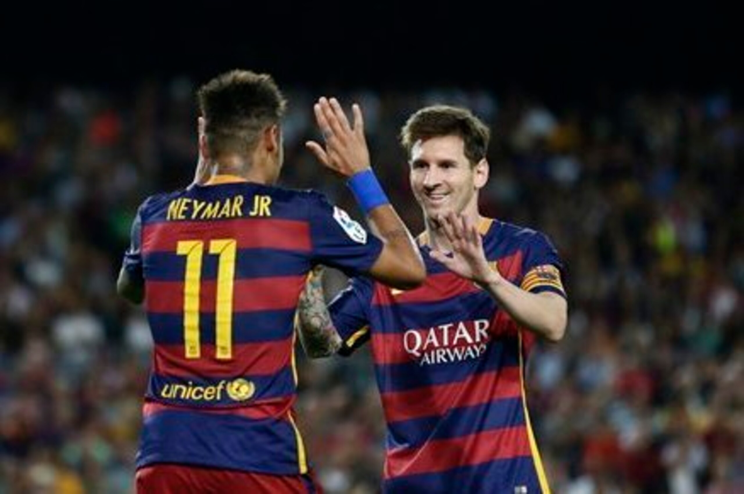 Neymar high-fives Messi.