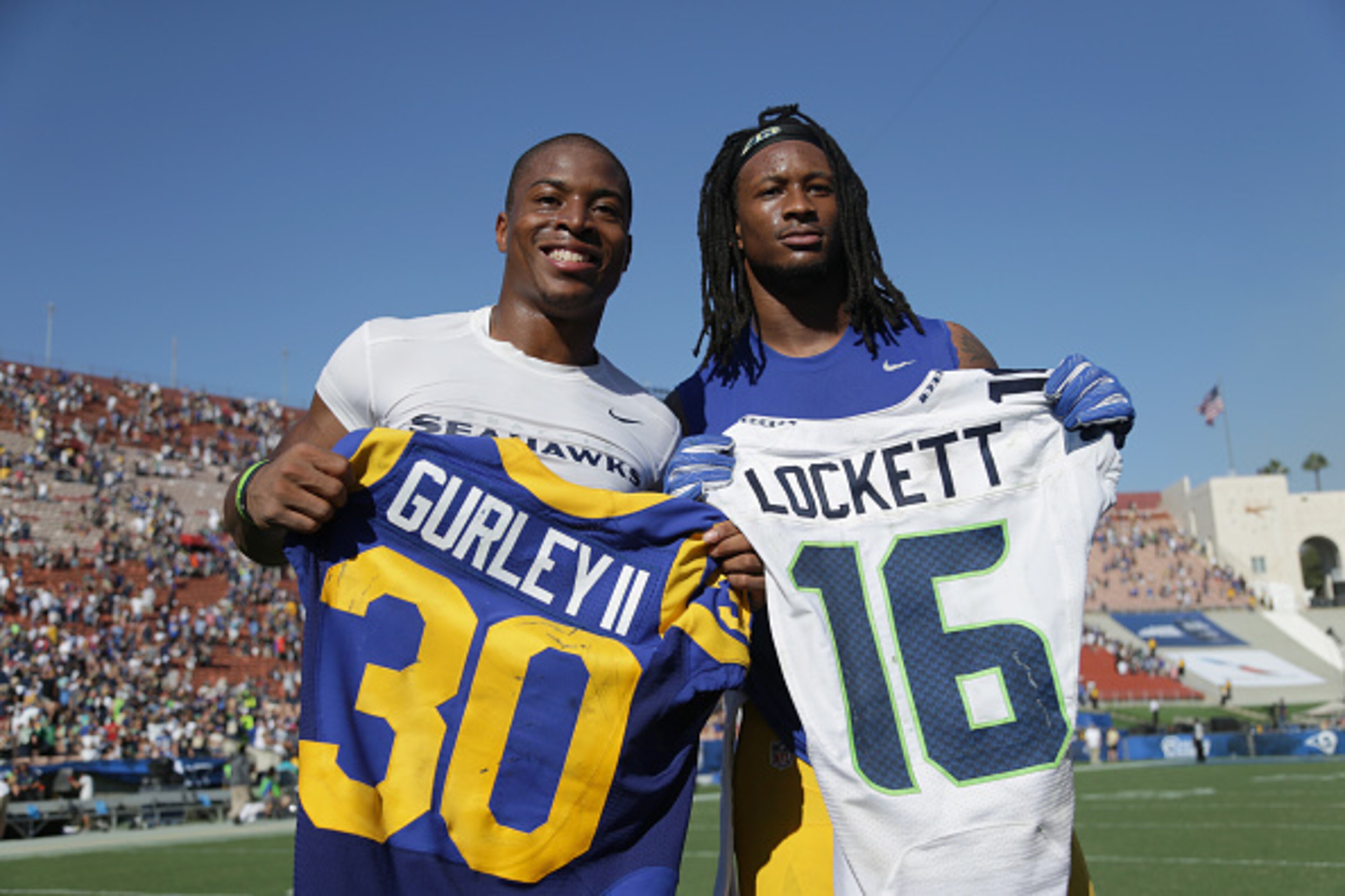 LOS ANGELES, CA - SEPTEMBER 18: Tyler Lockett #16 of the Seattle Seahawks (L) exchanges jerseys with Todd Gurley #30 of the Los Angeles Rams after the Rams defeated the Seattle Seahawks 9-3 in the home opening NFL game at Los Angeles Coliseum on Septembe LOS ANGELES, CA - SEPTEMBER 18: Tyler Lockett #16 of the Seattle Seahawks (L) exchanges jerseys with Todd Gurley #30 of the Los Angeles Rams after the Rams defeated the Seattle Seahawks 9-3 in the home opening NFL game at Los Angeles Coliseum on Septembe