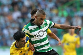 LISBON, PORTUGAL - AUGUST 28: Sporting CP's forward Islam Slimani from Algeria tackled by FC Porto's defender from Spain Ivan Marcano during the Primeira Liga match between Sporting CP and FC Porto at Estadio Jose Alvalade on August 28, 2016 in Lisbon, Po