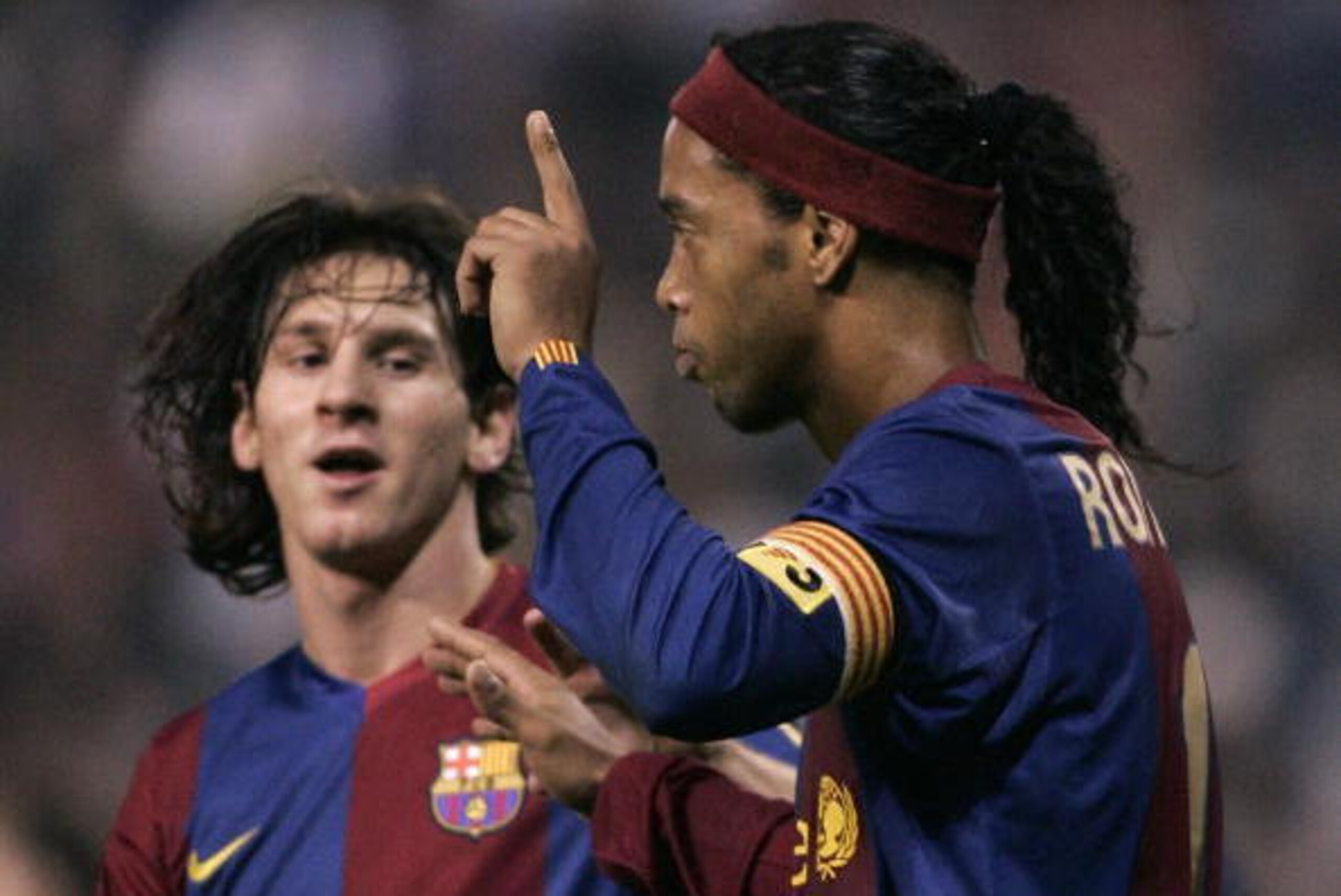 CORUNA, SPAIN:  FC Barcelona?s Brazilian Ronaldo de Assis 'Ronaldinho' celebrates with teammate Argentine Lionel Messi after scoring against Deportivo Coruna's during their spanish first League football match at the Riazor Stadium in Coruna, northwestern 