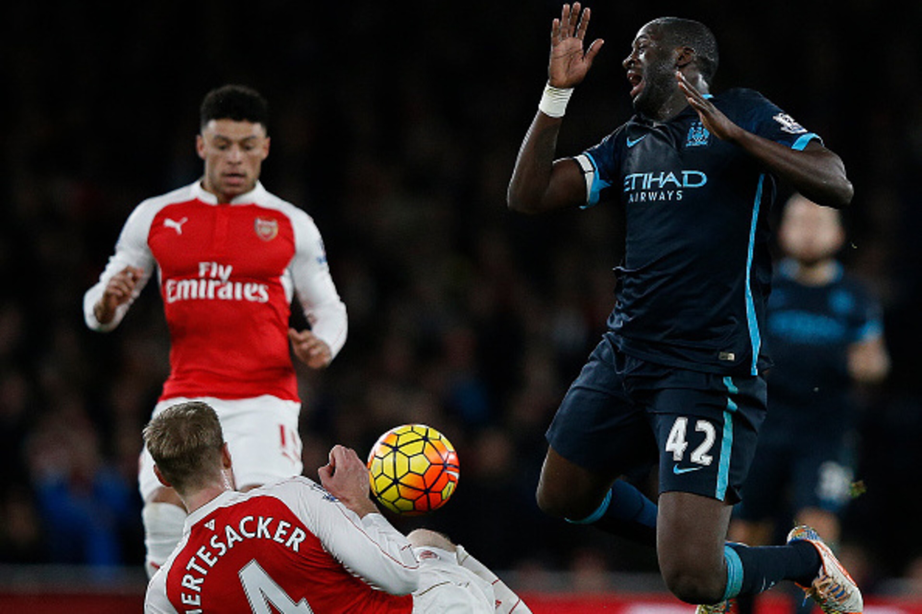 Arsenal's German defender Per Mertesacker (C) vies with Manchester City's Ivorian midfielder and captain Yaya Toure during the English Premier League football match between Arsenal and Manchester City at the Emirates Stadium in London on December 21, 2015
