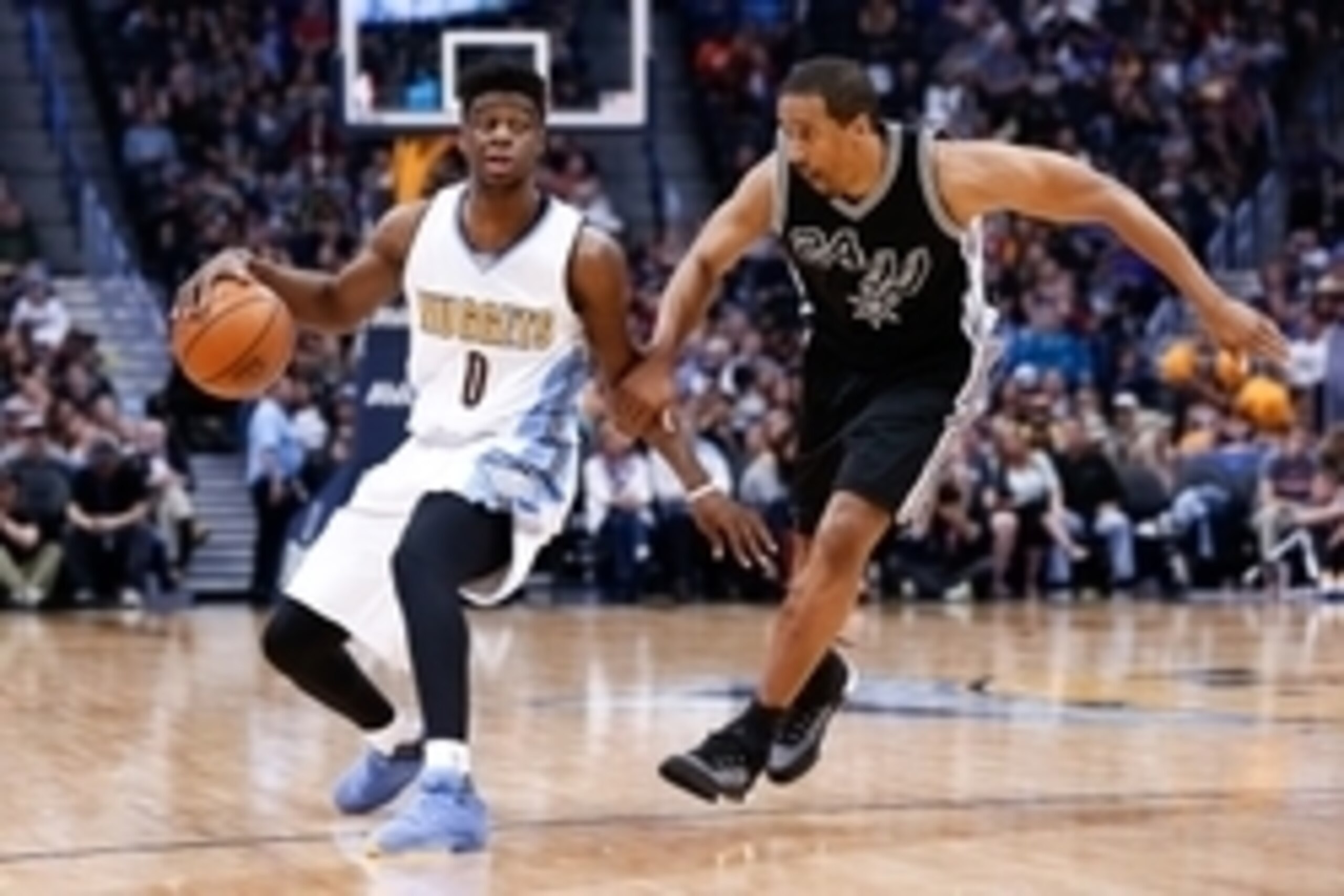 Apr 8, 2016; Denver, CO, USA; San Antonio Spurs guard Andre Miller (24) guards Denver Nuggets guard Emmanuel Mudiay (0) in the fourth quarter at the Pepsi Center. The Nuggets defeated the Spurs 102-98. Mandatory Credit: Isaiah J. Downing-USA TODAY Sports