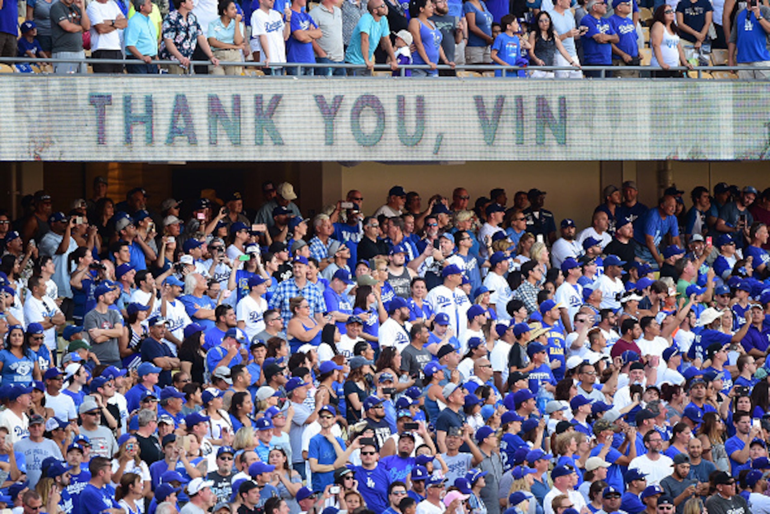 LOS ANGELES, CA - SEPTEMBER 25:  Fans cheer as Los Angeles Dodgers announcer Vin Scully speaks to fans during his final home game as he retires at the end of his 67th season after a 4-3 win over the Colorado Rockies at Dodger Stadium on September 25, 2016