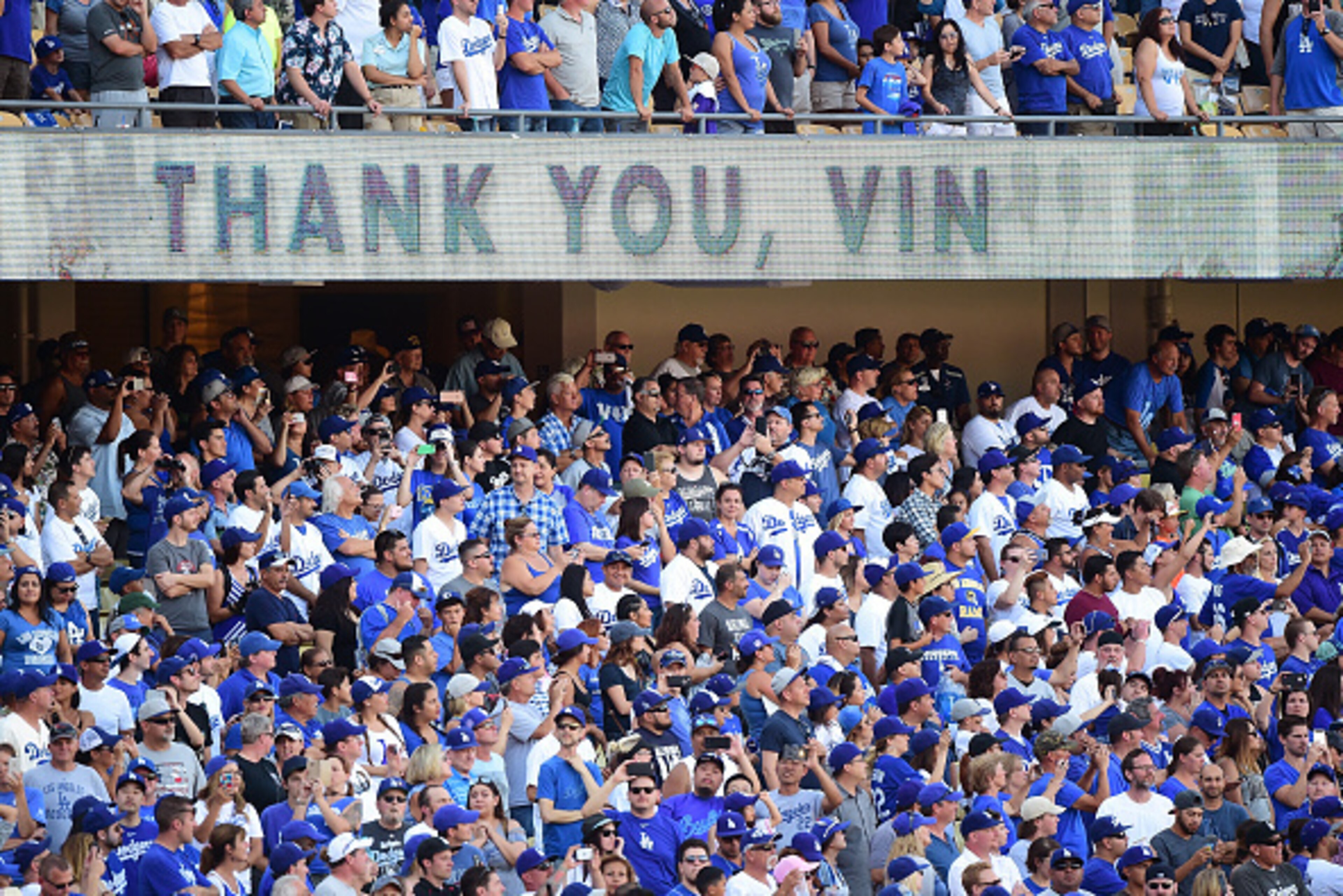 LOS ANGELES, CA - SEPTEMBER 25:  Fans cheer as Los Angeles Dodgers announcer Vin Scully speaks to fans during his final home game as he retires at the end of his 67th season after a 4-3 win over the Colorado Rockies at Dodger Stadium on September 25, 2016